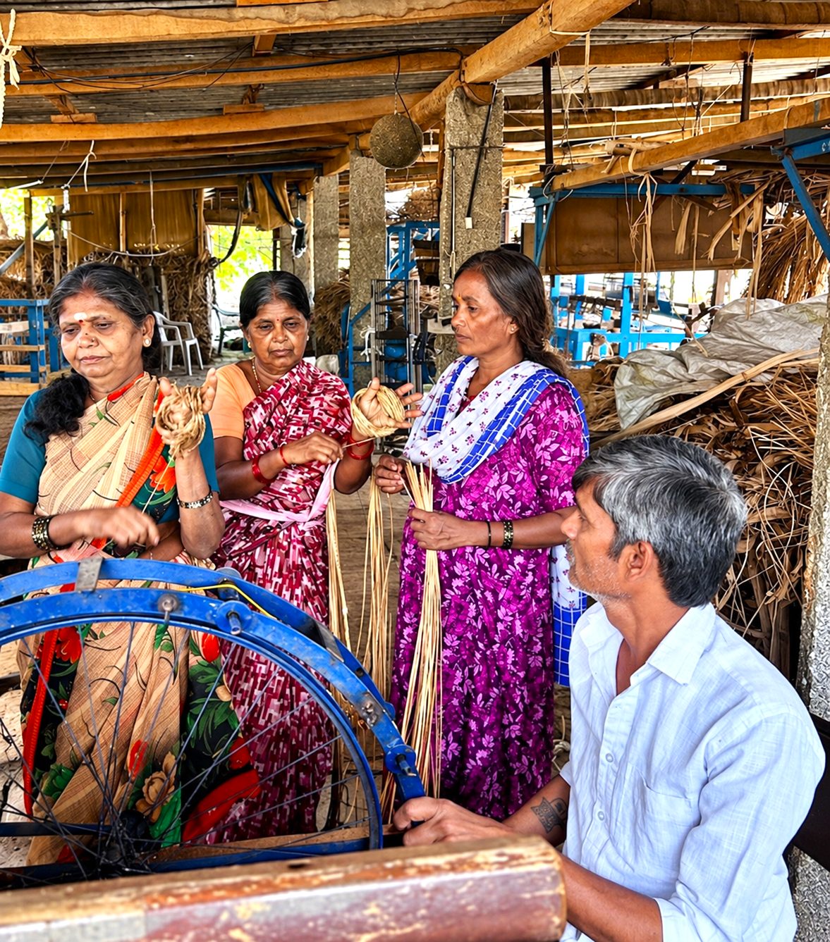 Women extracting banana fibre at a shared processing unit